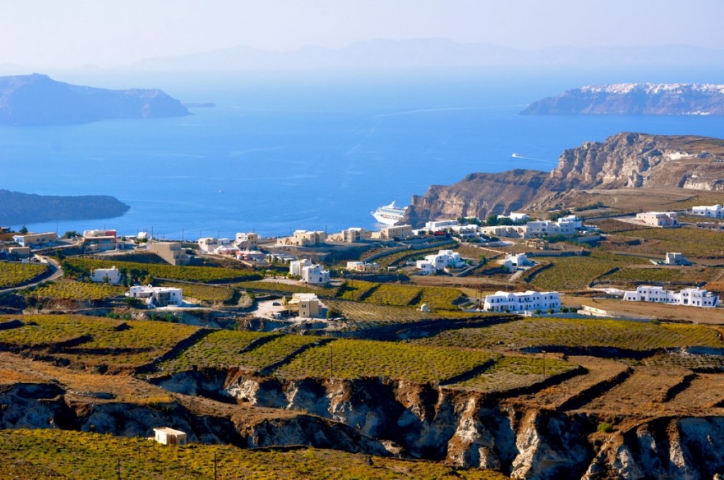 Alien vineyard landscapes, with the tourist-laden cruise ships docked crater-side in the background