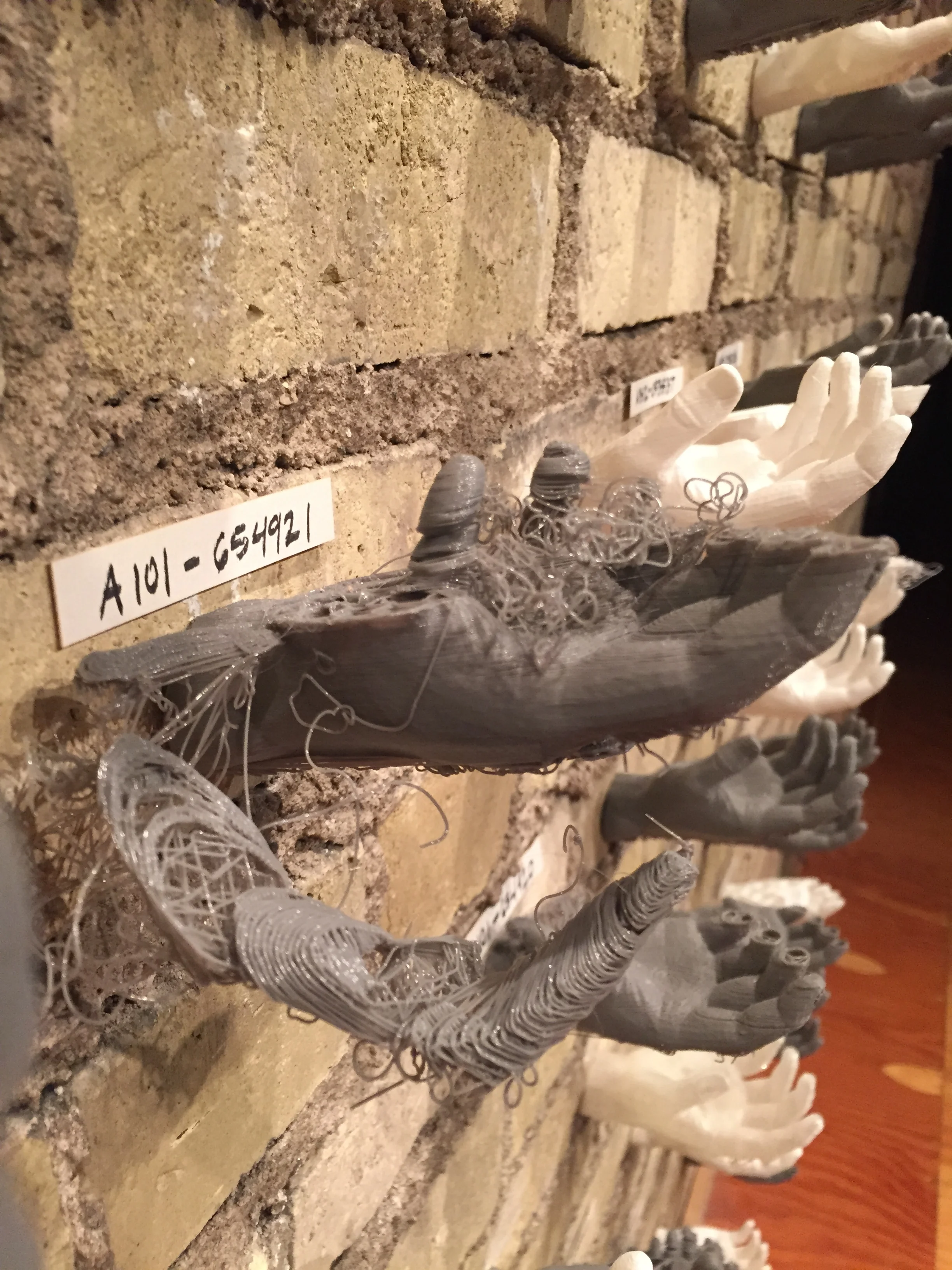  This wall adorned with prosthetic hands questions the value of the reproduction line.&nbsp; 