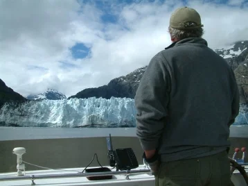 John at the flybridge helm of the Phalarope in upper Glacier Bay.