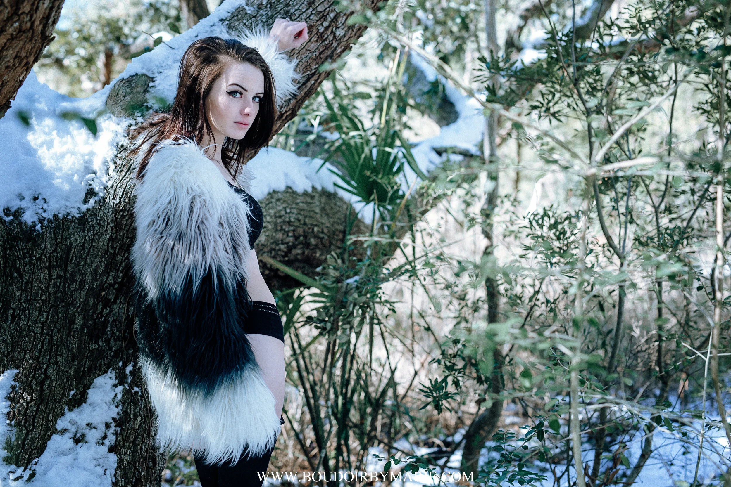 Brunette in high fashion faux fur coat photographed in the boudoir style outside in snow in Charleston, South Carolina.