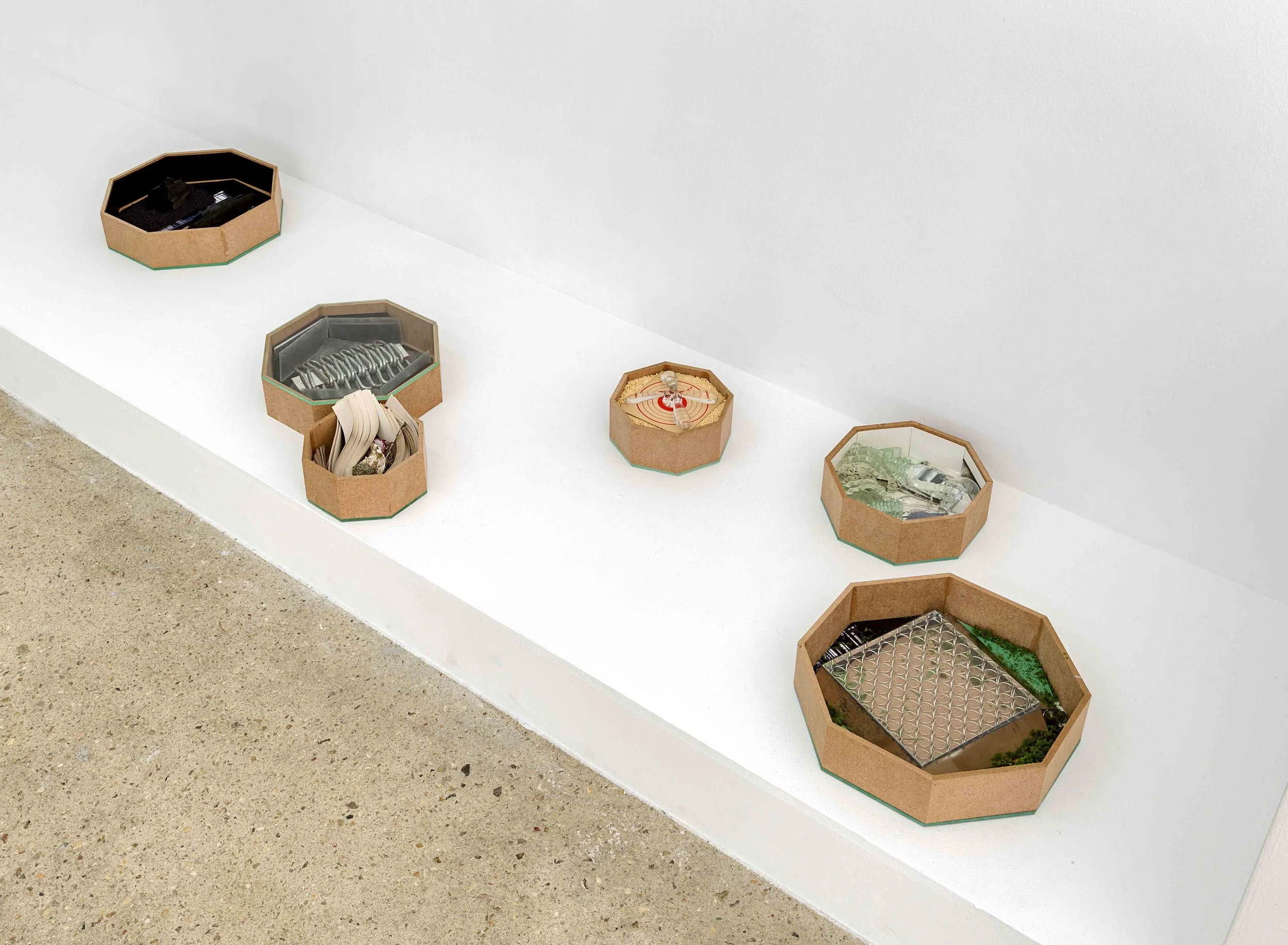Octogardens (2017) carbon paper, stones, charcoal, fabric, paper, wood, glass, plexiglas, metal chain, metal, shells, inkjet print, sand paper, artificial moss octogonal boxes, octogonal glass lids largest: 26,6 x 26,6 x 6 cm / smallest: 14,5 x 14,5 x 6 cm installation view, Arnaud Deschin Galerie, Paris, 2017 photo © Romain Darnaud