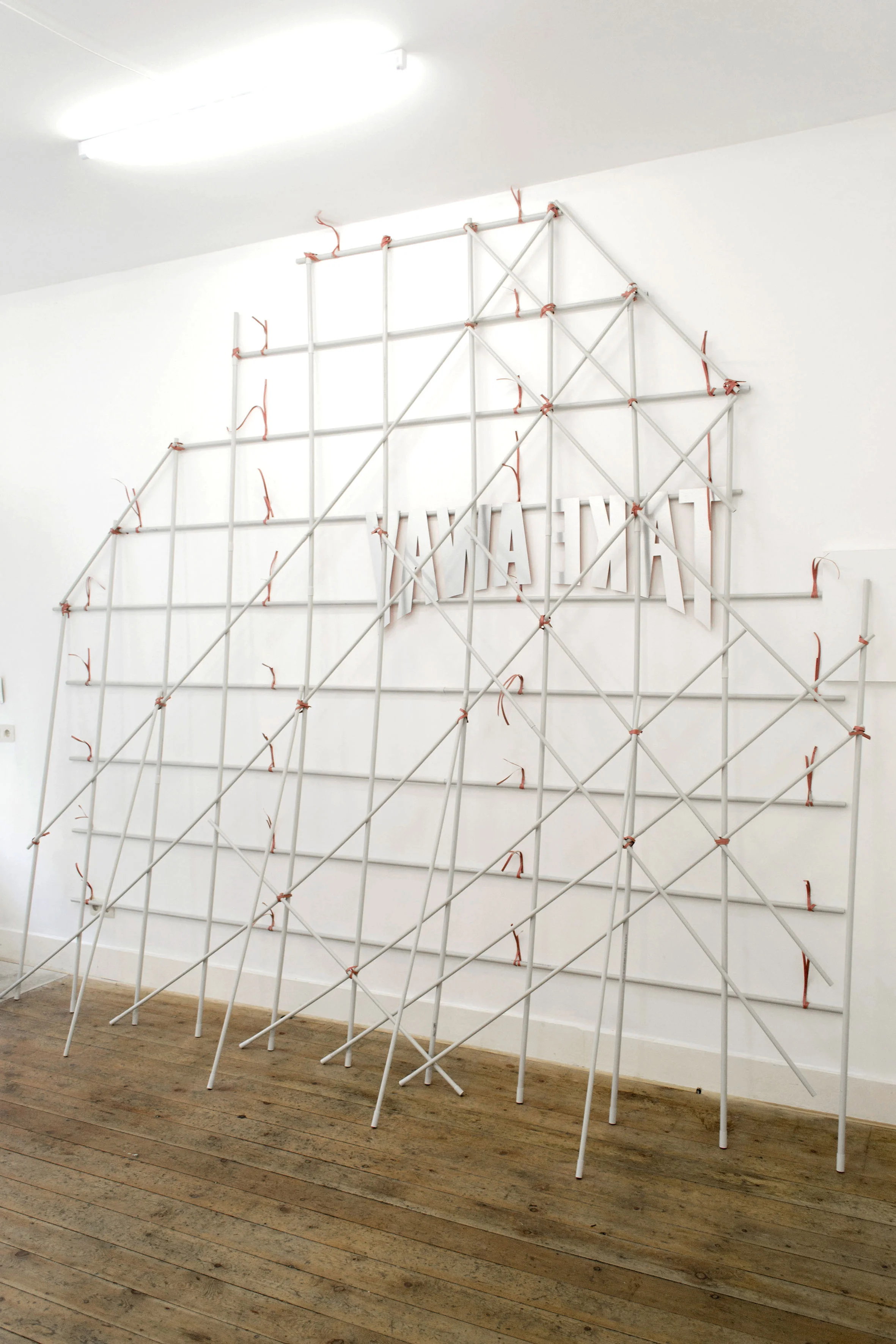 Take Away , 2019 PVC tubes, aluminum letters, Bali ties, 320 x 350 x 70 cm