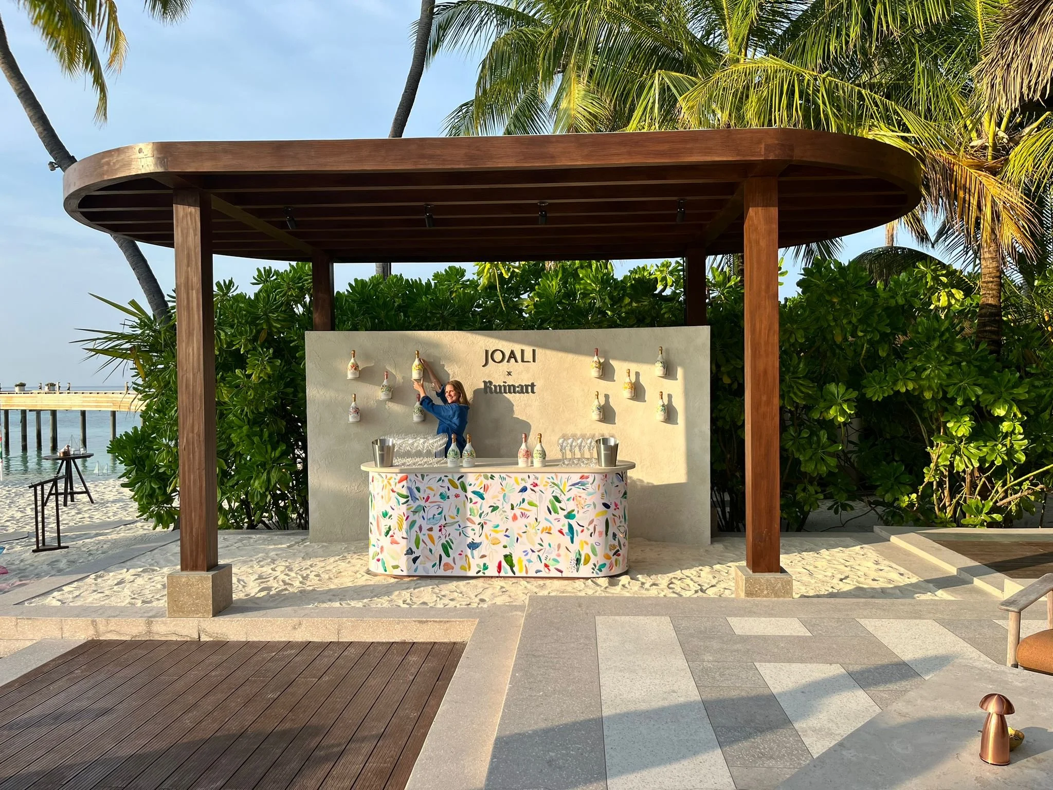  In November 204, Sophie Kitching was invited to celebrate the 6th Anniversary of JOALI Maldives in partnership with Maison Ruinart. Commissioned to transform ecodesigned second skins Champagne bottles with her signature painting skills involving viv