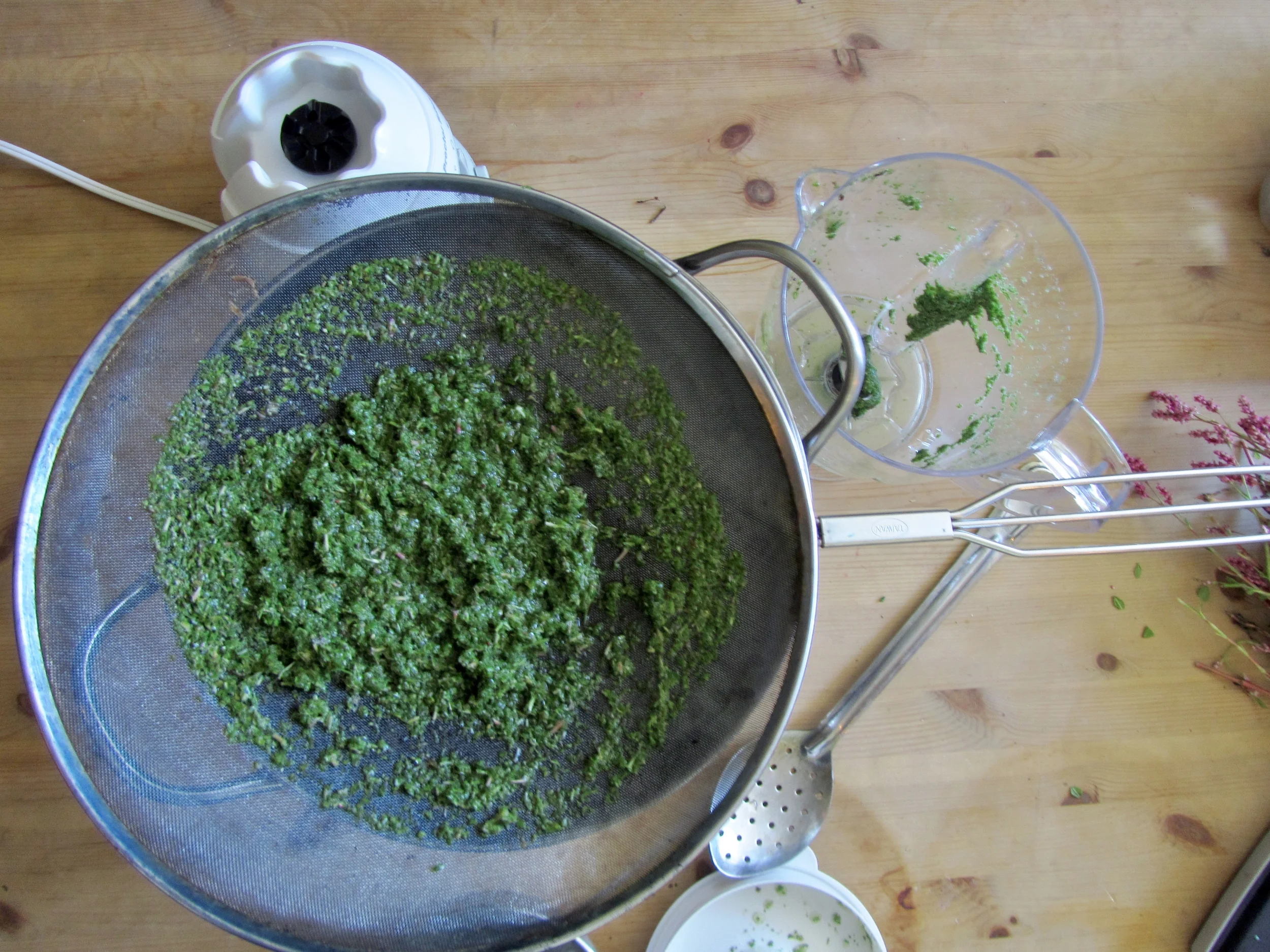 Strained indigo leaf bits are saved to use for a later dye process after the fresh leaf dyeing