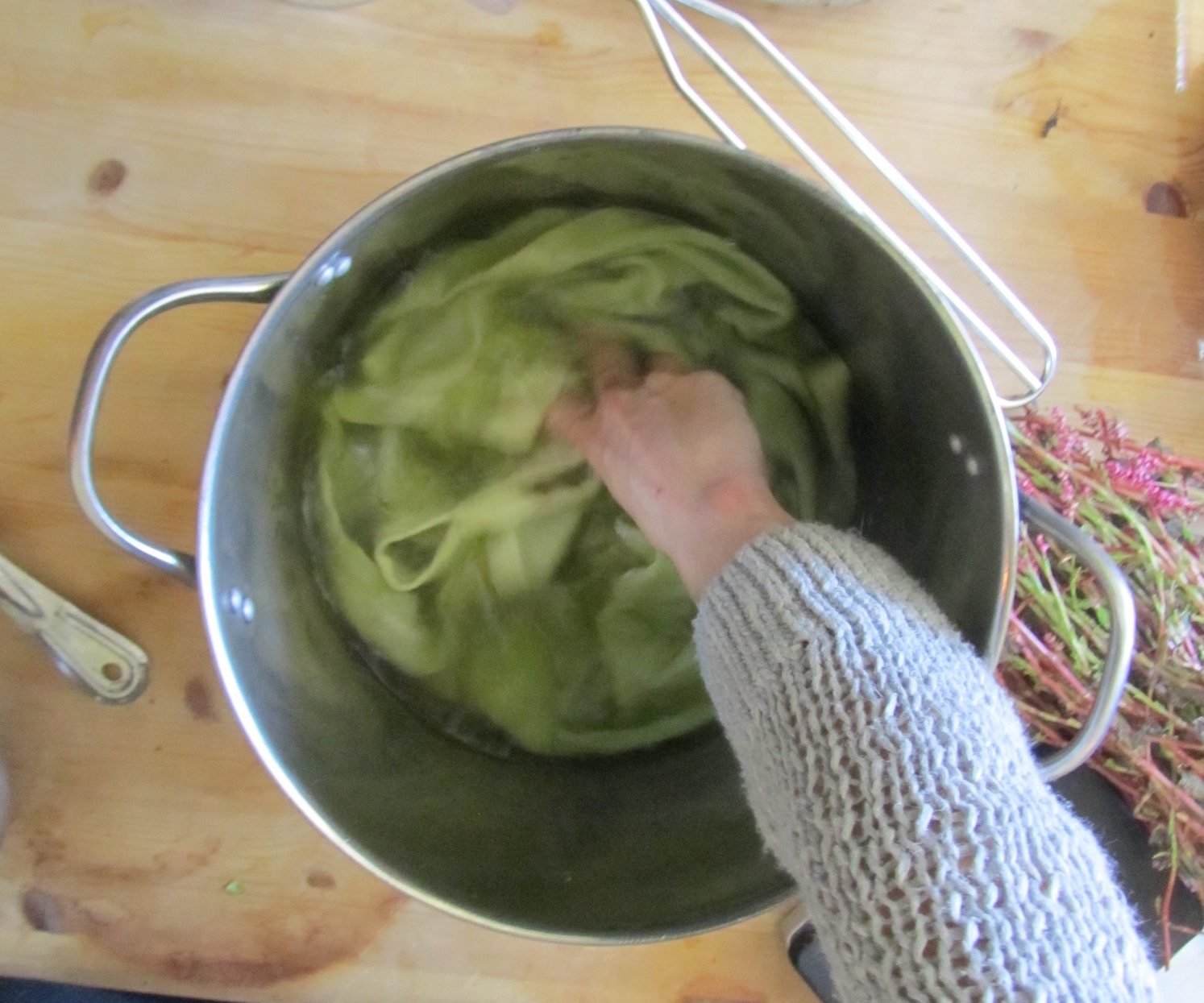 Stirring the top in the strained indigo water solution for 3-5 minutes