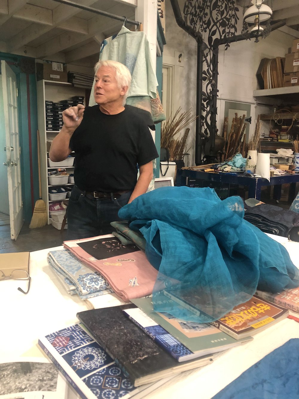  John Marshall in his studio with a cloud of fresh leaf dyed silk 