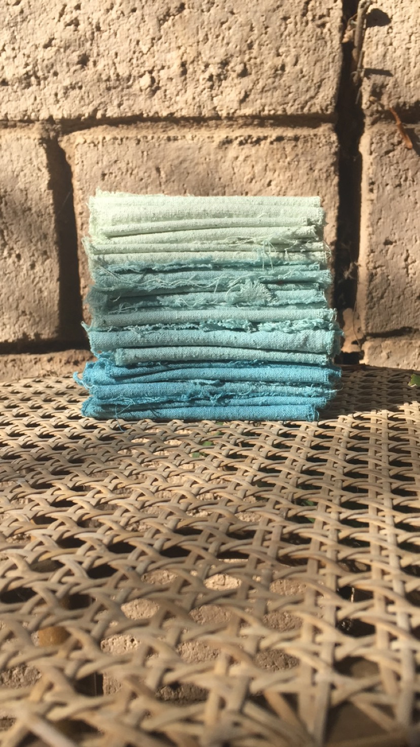  fresh indigo dyed raw silk- from bottom to top a range of blues and greens produced as the dye bath exhausts 