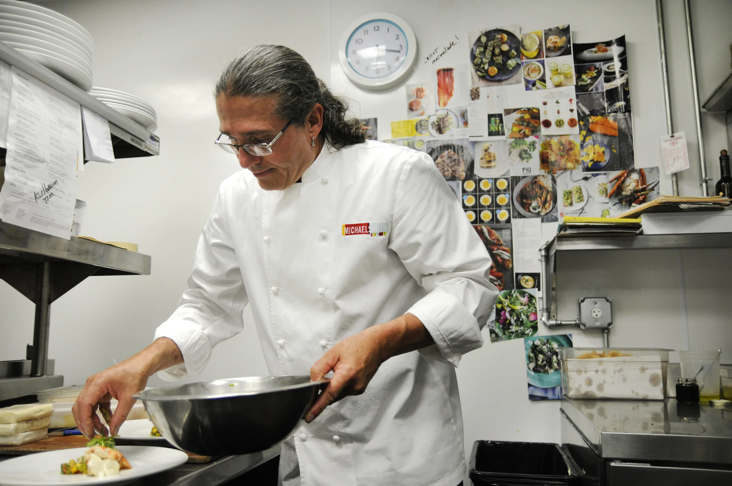 Chef Michael Smith plating the signature lobster anniversary dish. Check out his inspiration wall in the background! 