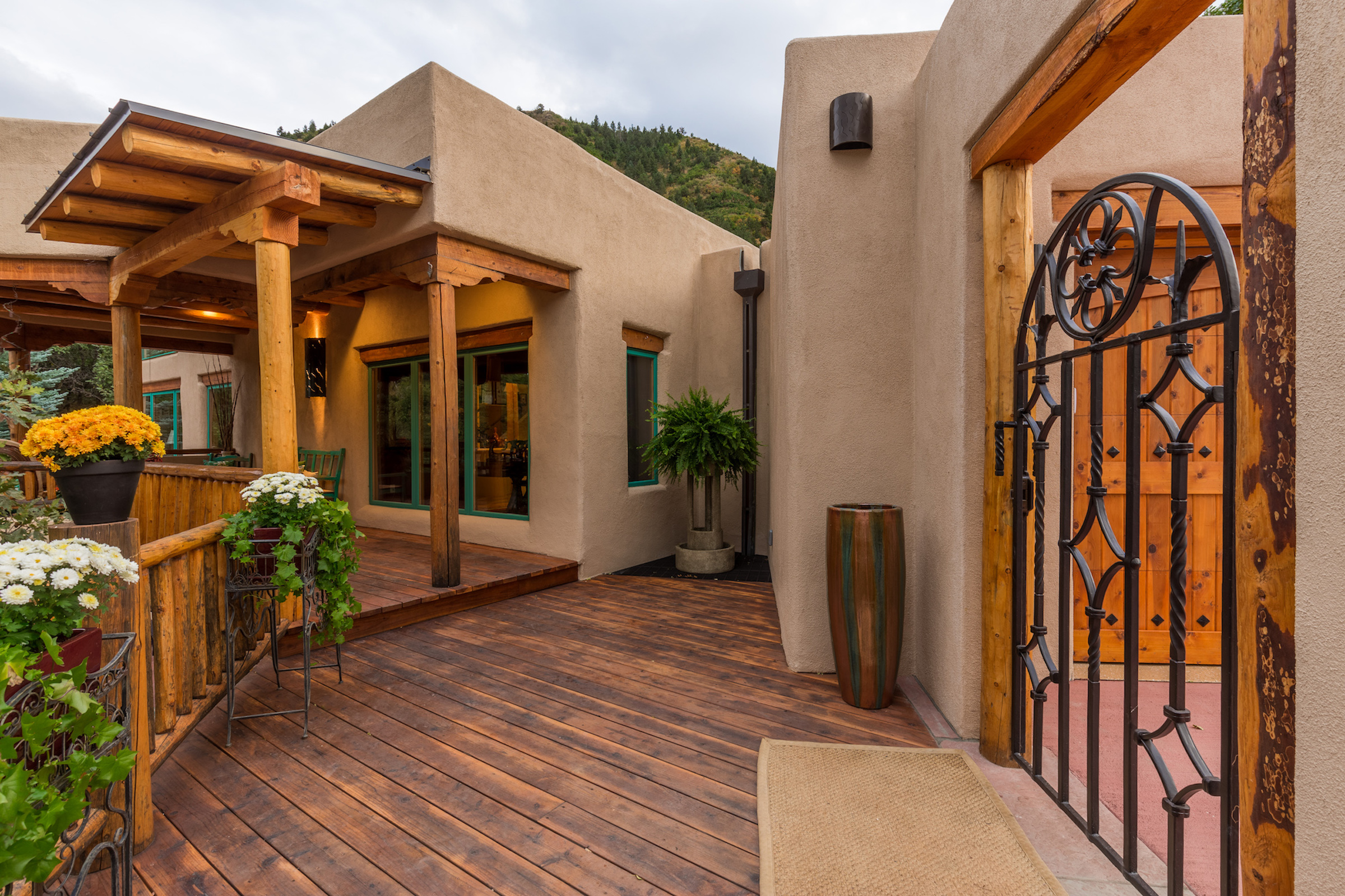Rebuilt entry deck with vigas, corbels, log posts, and rails
