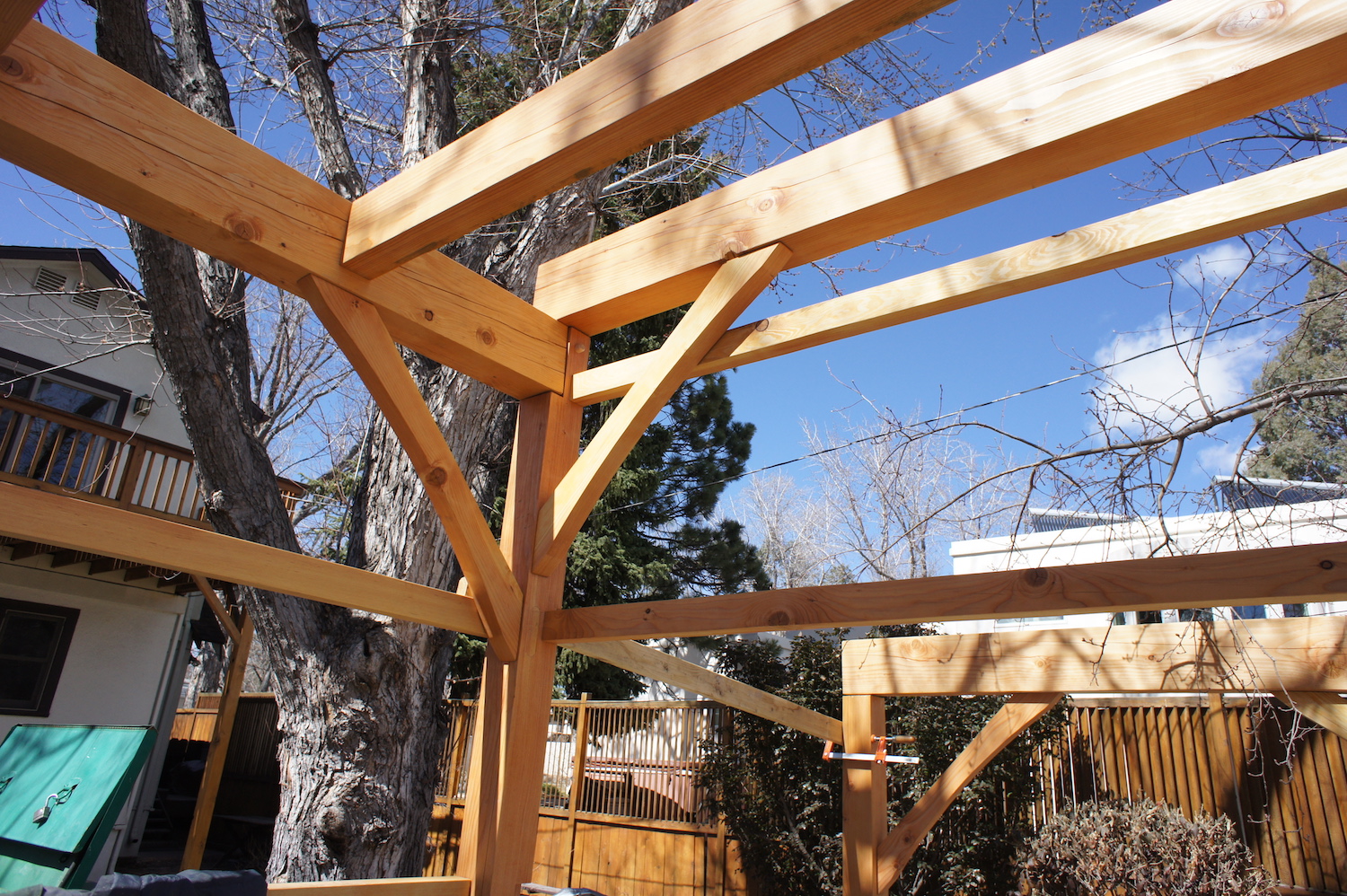 Joists dovetail into main girt beams. Knee braces are tenoned into posts and beams.