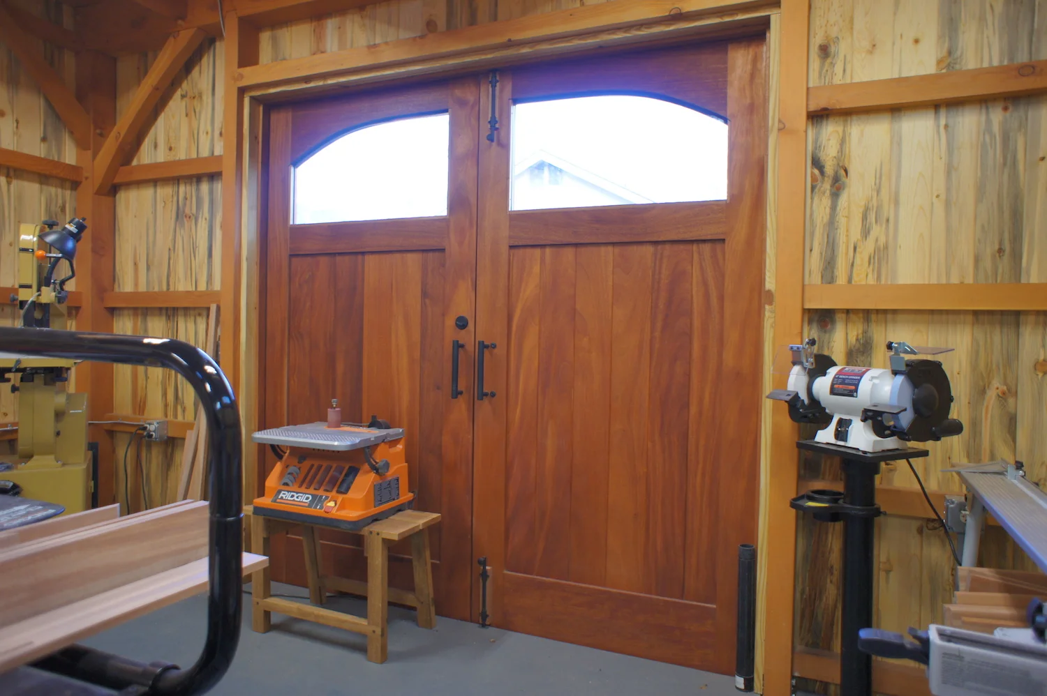  These large mahogany doors, built for this job, make it easy to move materials and equipment into the shop. 