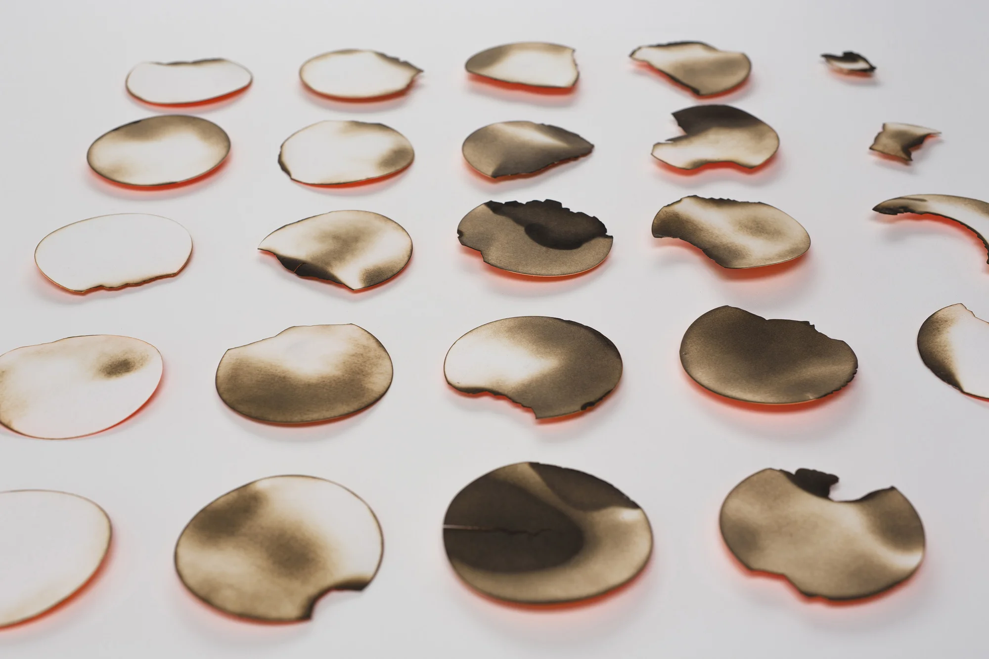 Kelly M. O'Brien, Playing With Fire No. 35 (Phases 1) . Paper, spray paint, flame. 28 x 28 x .5 inches. ©2016. Private collection.