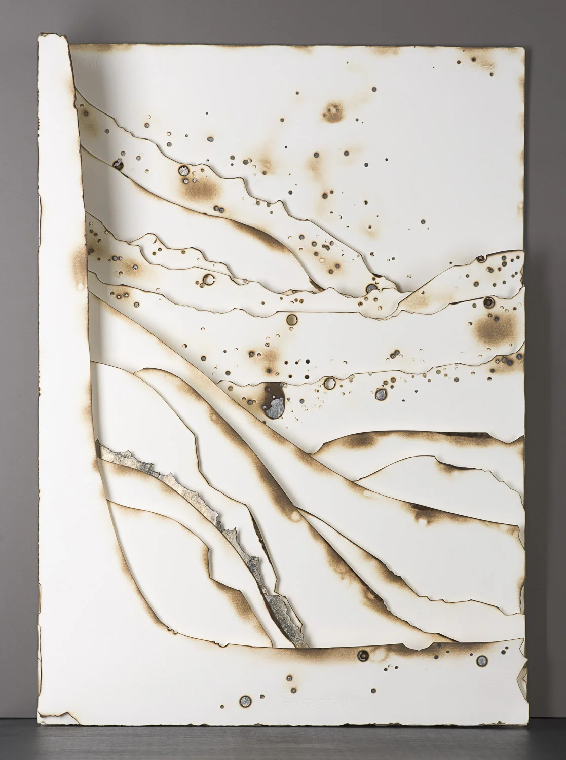 Kelly M. O'Brien, Playing With Fire No. 33 . Paper, gold leaf, flame. 27.5 x 19.5 x 4.2 inches. ©2016. Commissioned for Norwegian Cruise Lines Joy .