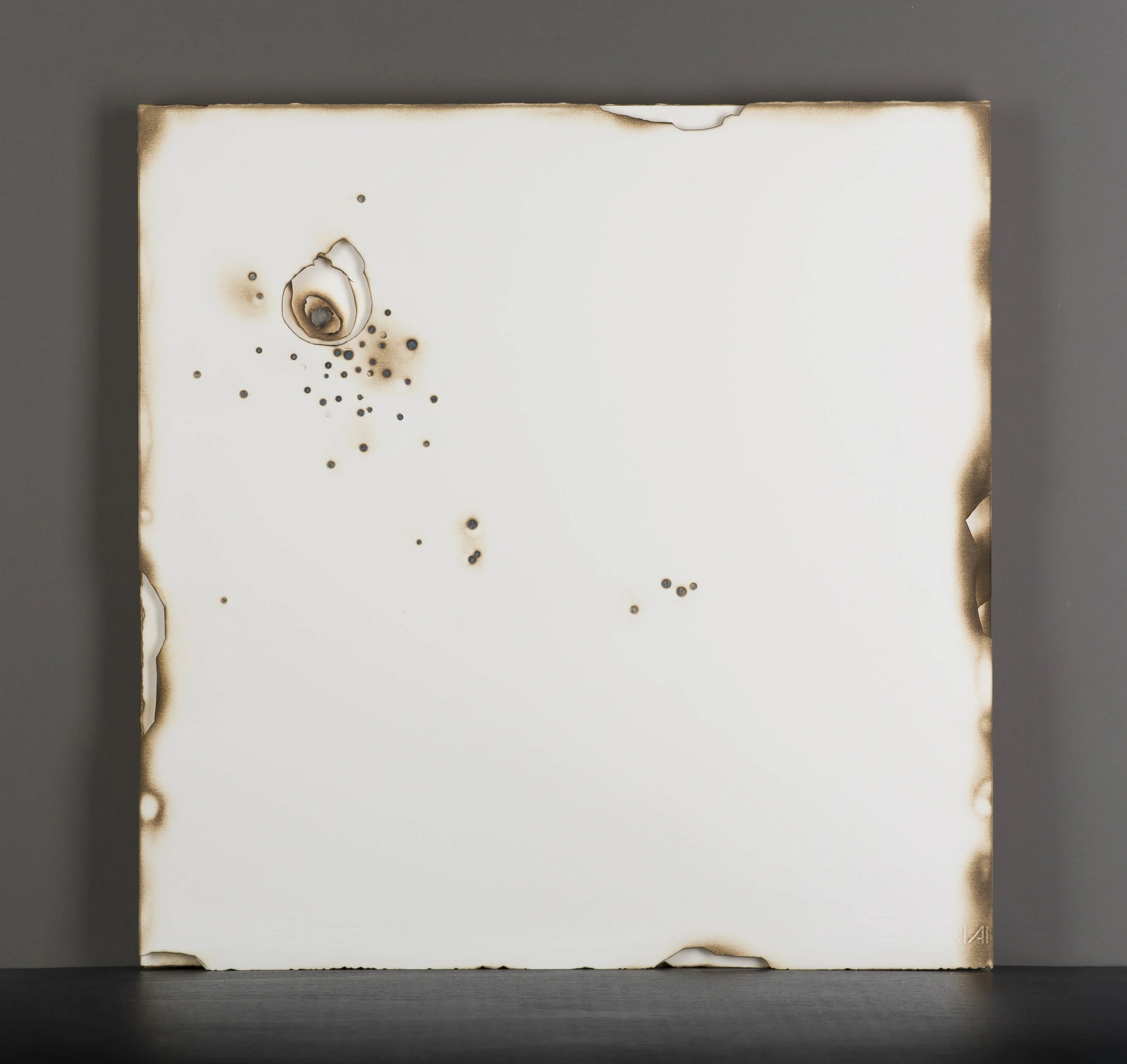 Kelly M. O'Brien, Playing With Fire No. 66 . Paper, gold leaf, flame. 20 x 20 x 1.25 inches. ©2017. One of a set of a four-piece series commissioned for Kimpton The Rowan Palm Springs, Jasper Boardroom. ©2017.