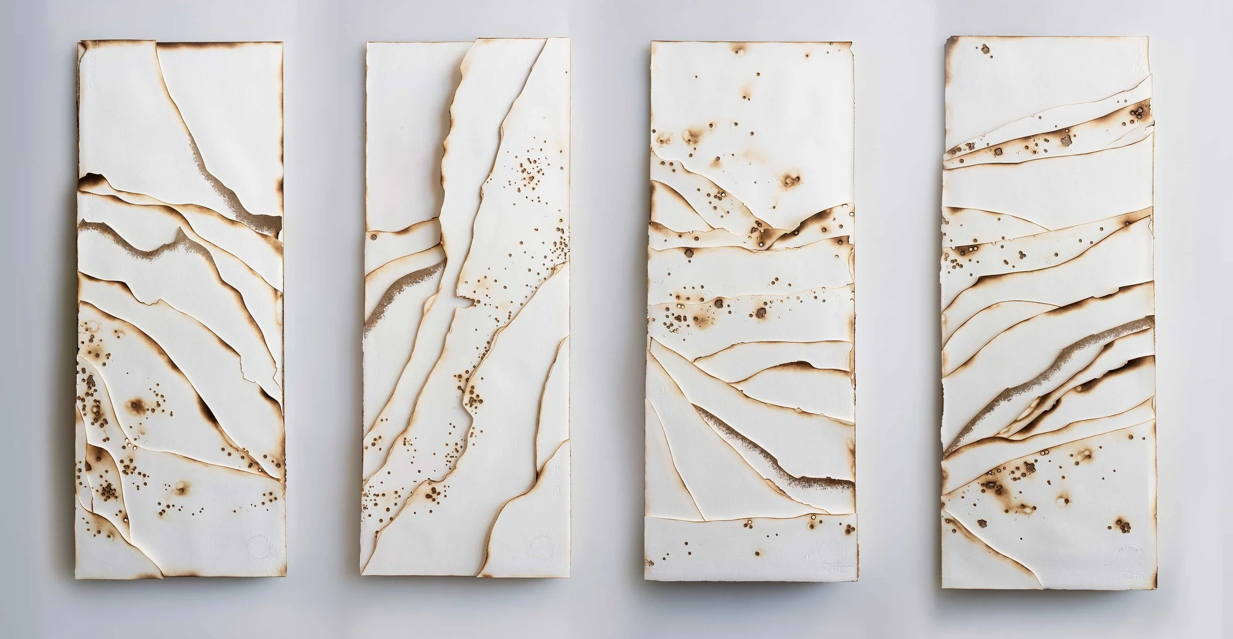 Kelly M O'Brien, Playing With Fire No. 90-93 . Paper, gold leaf, flame. 36 x 14 x 1.5 inches. 91 x 36 x 4 cm. ©2019 | Commissioned as a set for Norwegian Cruise Line Getaway.