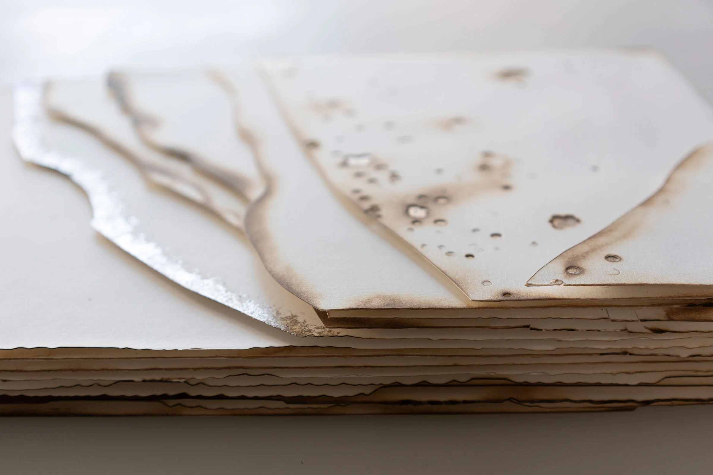 Kelly M O'Brien, Playing With Fire No. 90 (detail). Paper, gold leaf, flame. 36 x 14 x 1.5 inches. 91 x 36 x 4 cm. ©2019 | Commissioned as a set of four for Norwegian Cruise Line Getaway.