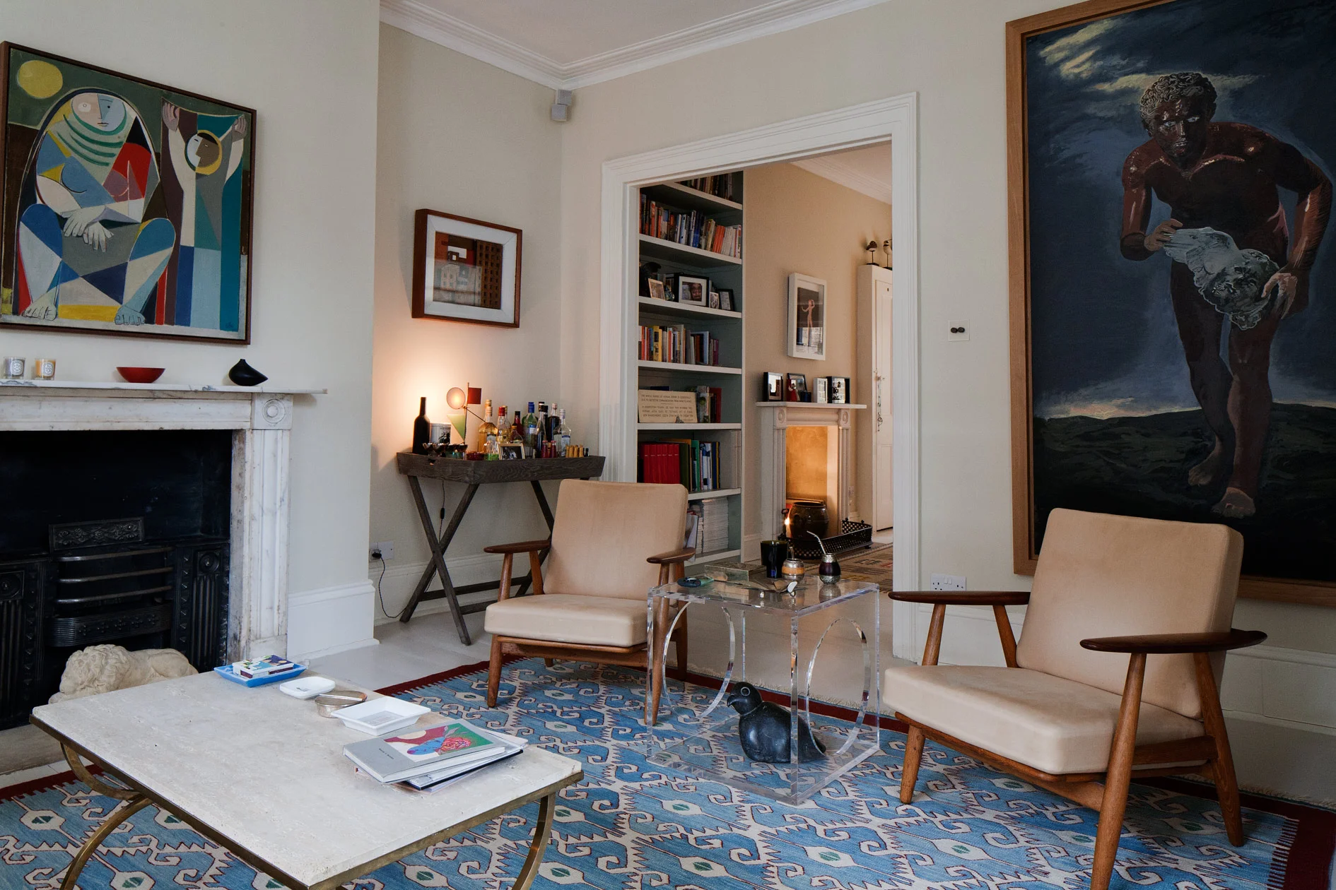 Interiors of bookcases are painted in colours inspired by the adjacent paintings and outside view