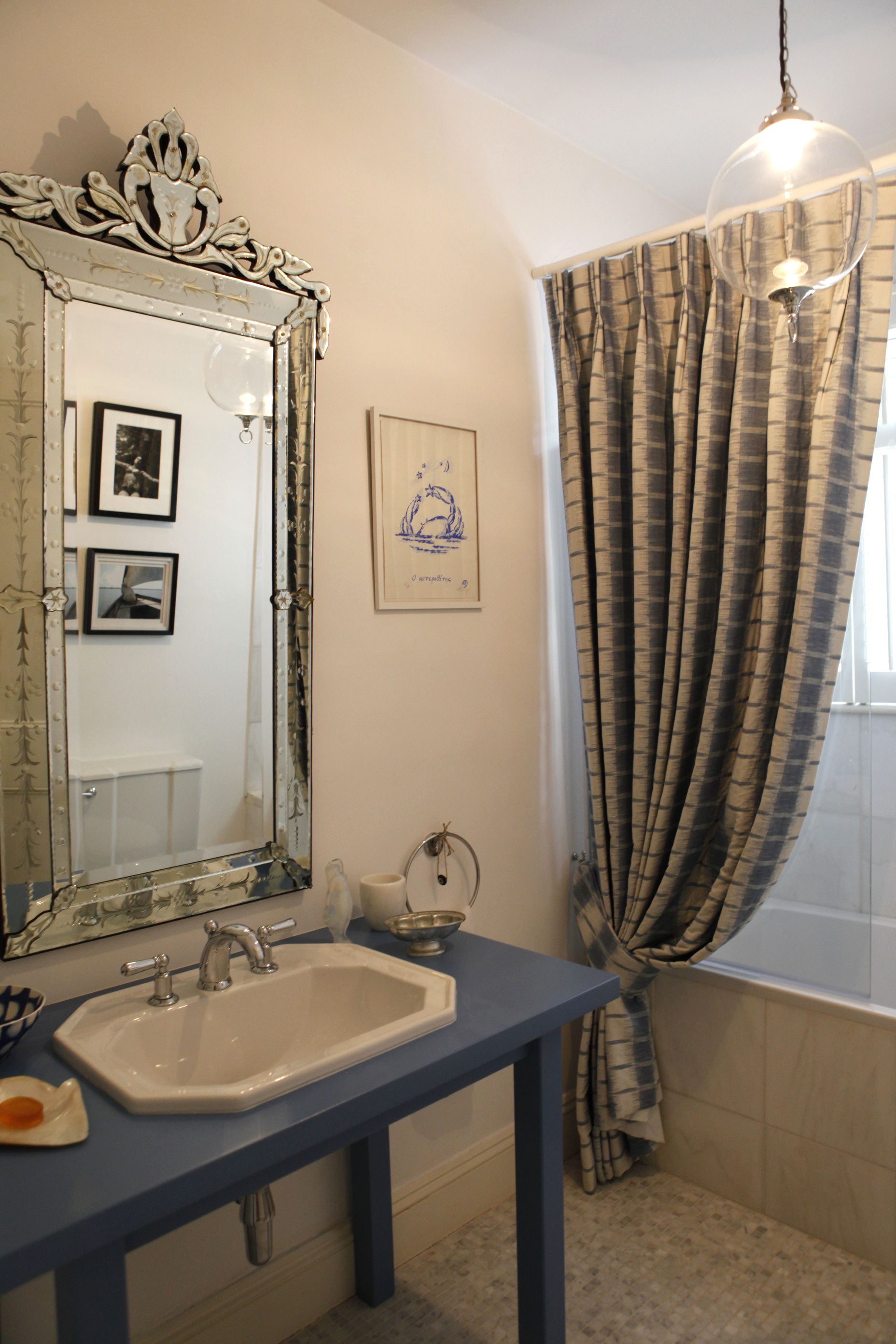  Bathroom in marble and Mykonos blue with hand woven linen curtain 