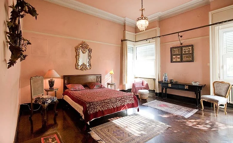 The terracotta walls, the dappled light and sparse furniture makes this an infinitely relaxing bedroom