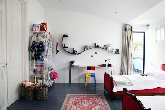 I love the simplicity of this bedroom - the rug on the floor, the quirky chair, the clever storage for toys. It is peaceful and inspiring.