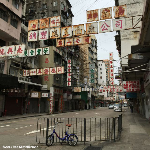 Except for the vehicles in the distance, this could be Hong Kong in the 60s