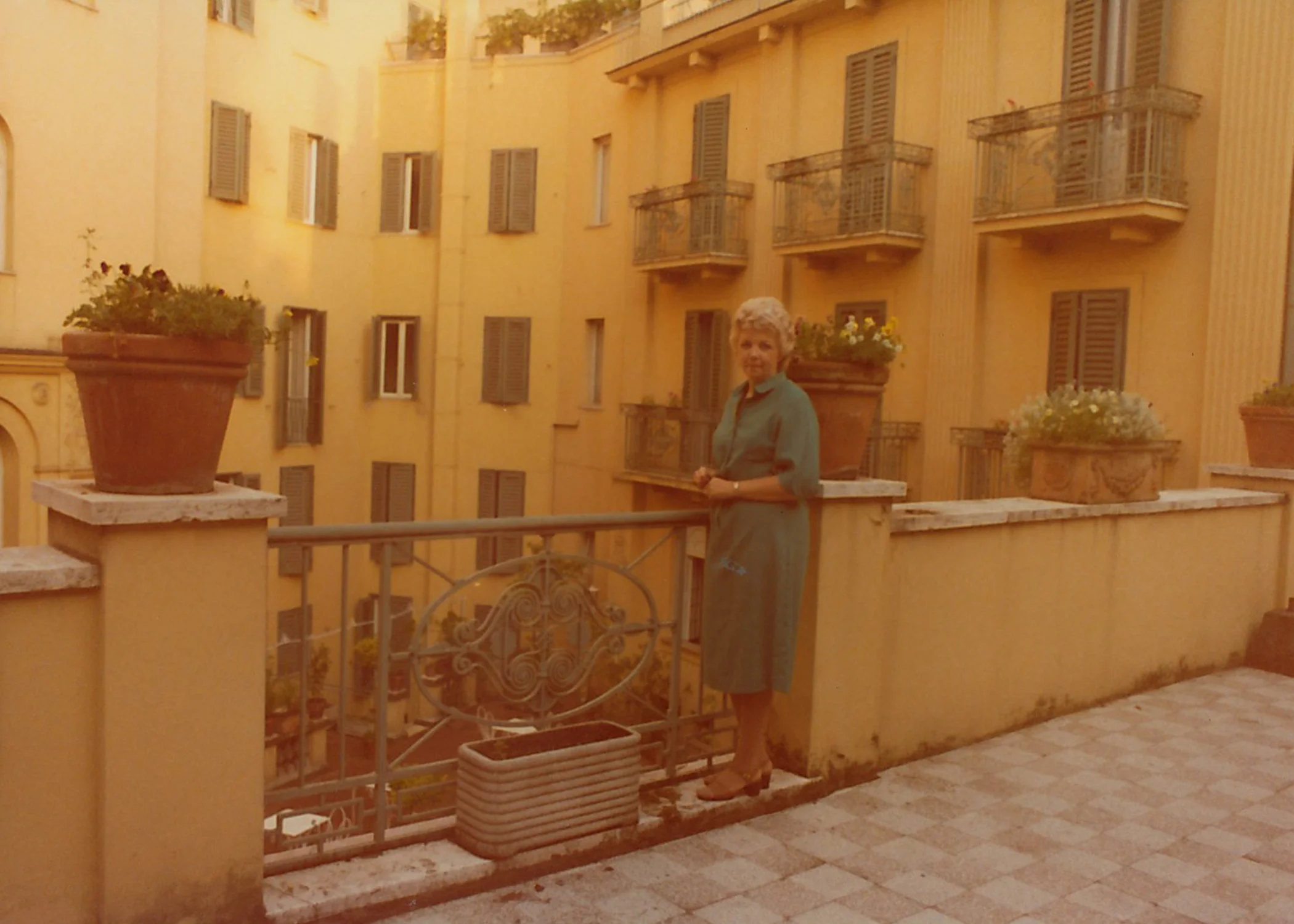 My pretty grandmother. The colors in this one are so lovely. This is Italy to me -- terra cotta pots of flowers and sun-faded buildings with terraces and shutters.