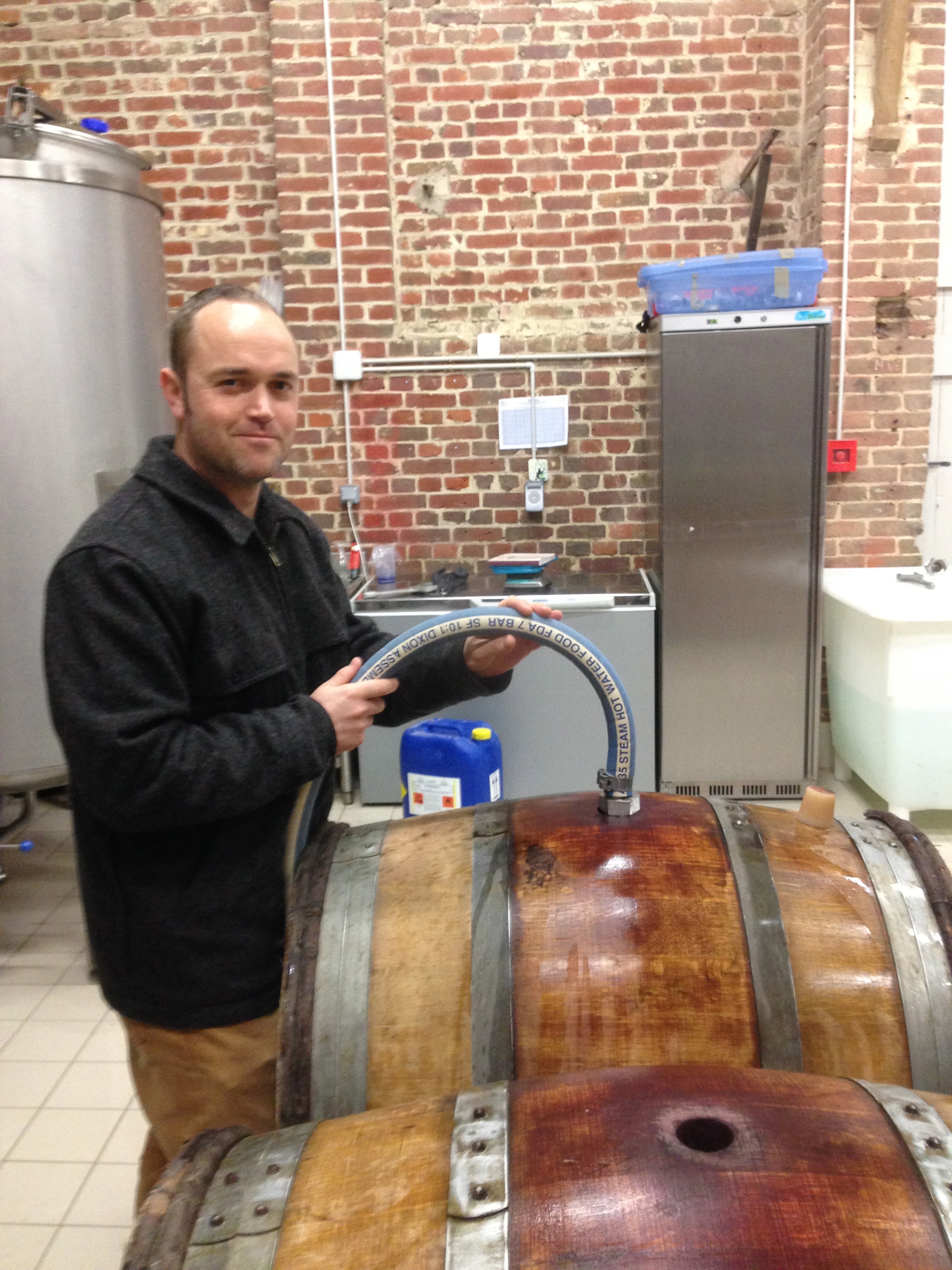 Nick rinsing the casks with hot water and checking for leaks..