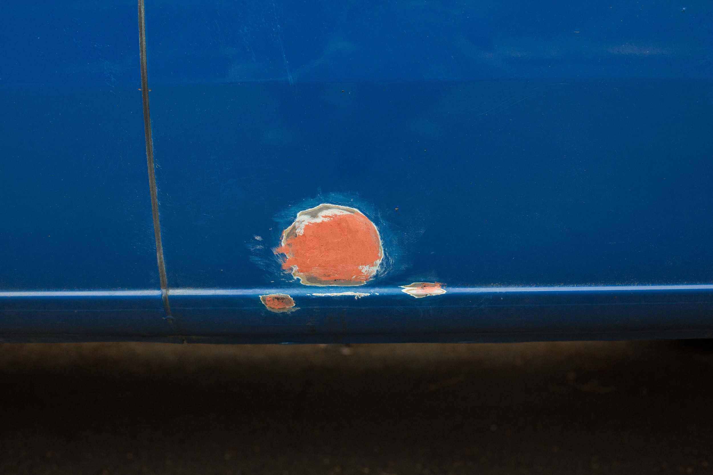 Spots of rust with putty on it. The large red spot is about the size of my fist. 
