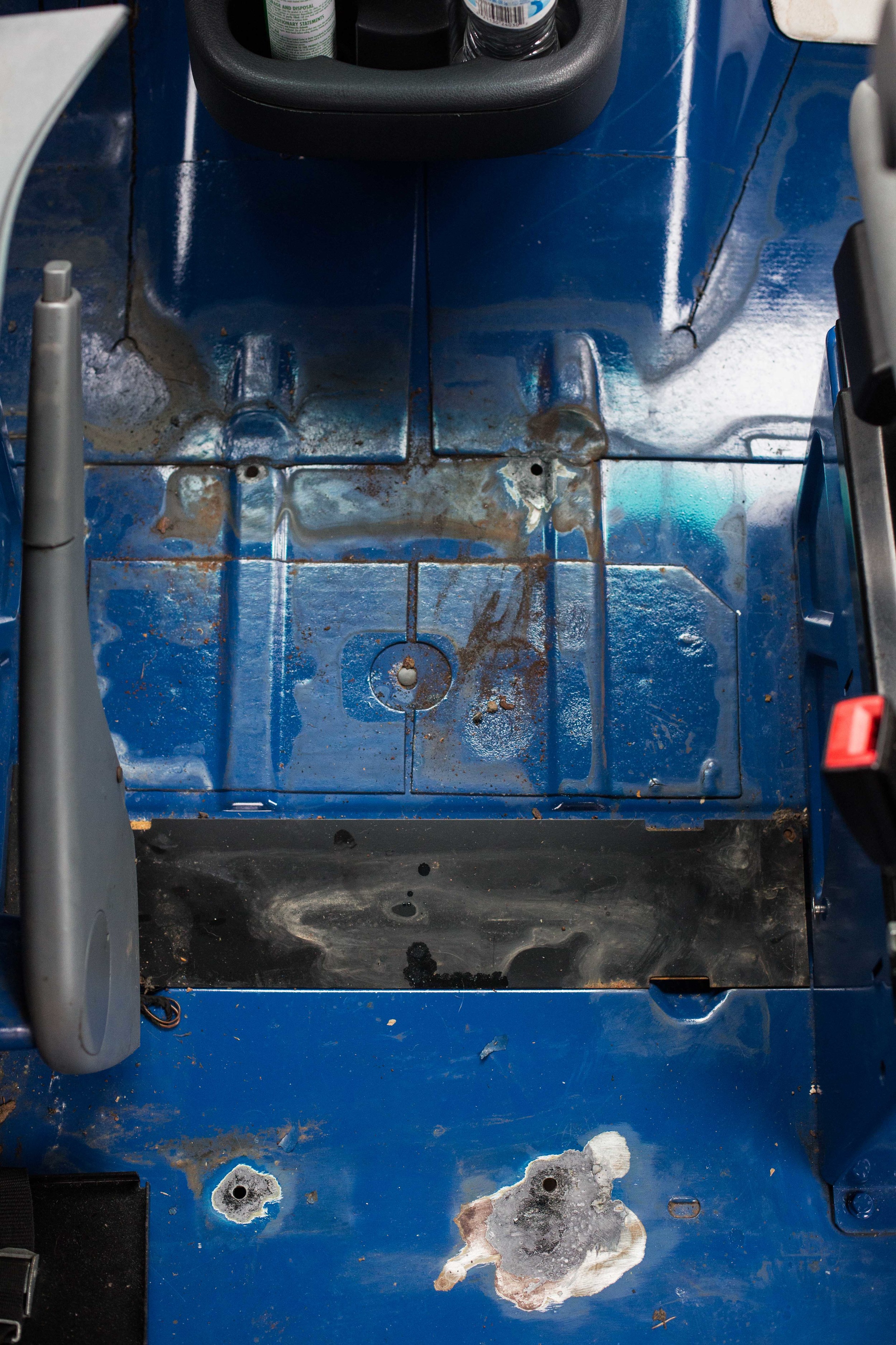 Rust spots left by the center filing console between the passenger and drivers seats. 