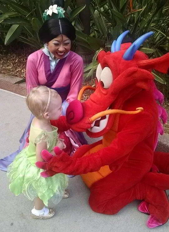 A Guide to Epcot with Kids - Mulan and Mushu greet guests, sign autographs and pose for pictures in the China Pavilion at Epcot.