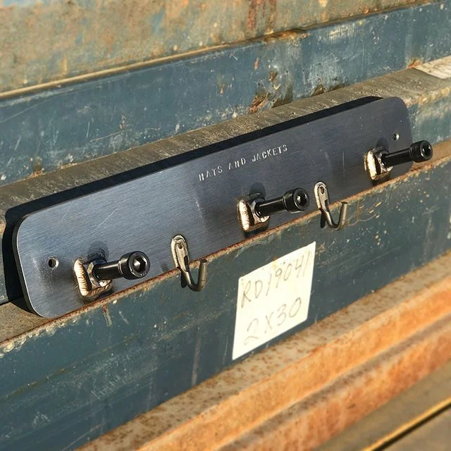 **Up For Grabs**
“HATS AND JACKETS” stamped industrial design coat rack. I made a very limited production run of these and this is the last remaining piece. Made from 1/4” steel plate, 1/2” socket head cap screws, square nuts, and rope hooks- Parts were machined, then TIG welded with Silicon Bronze. Holes spaced at 16” apart for easy mounting into studs. **$150.00 shipped anywhere in the mainland U.S.** DM me if interested. #madeinamerica #tigwelding #steel #industrialdesign #coatrack