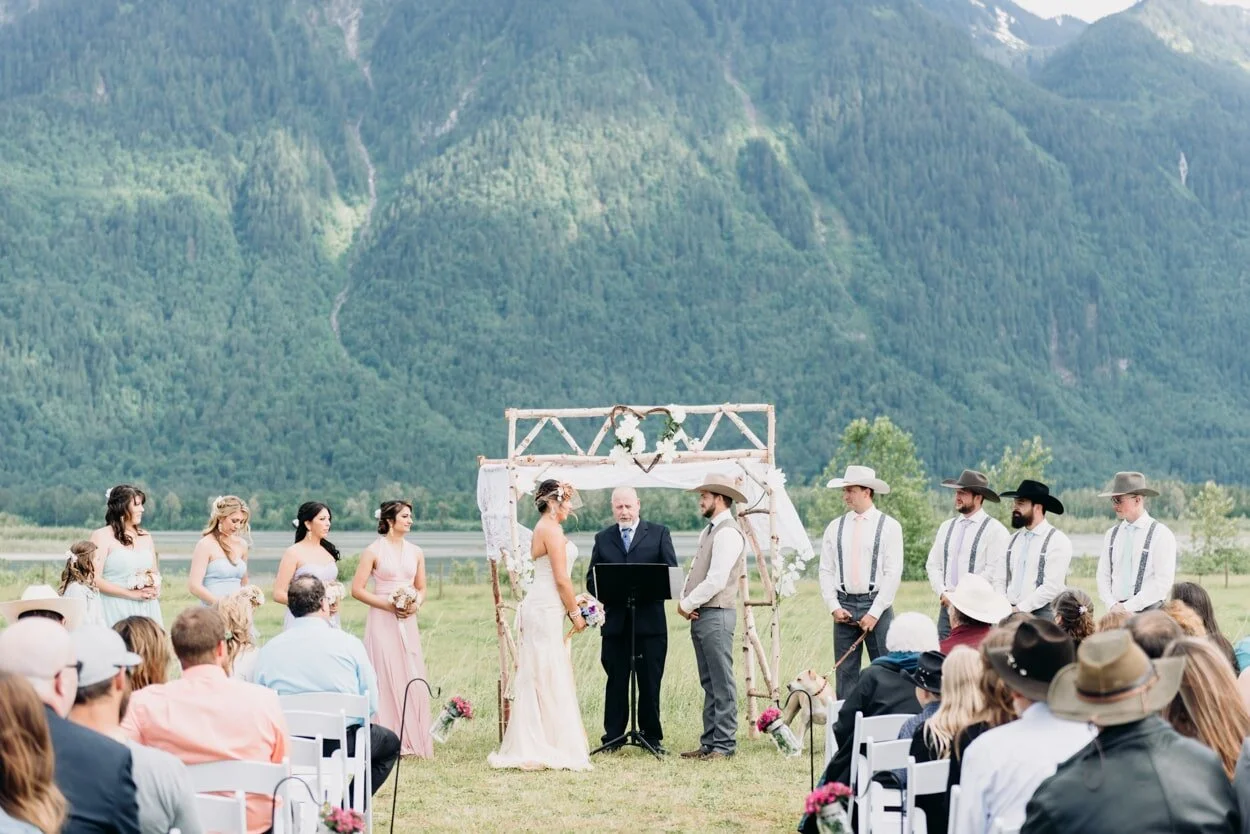 Bride and groom at their ceremony with a mountain backdrop