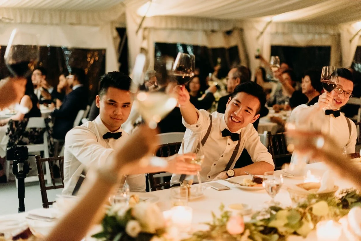 Groomsmen cheersing at a wedding reception