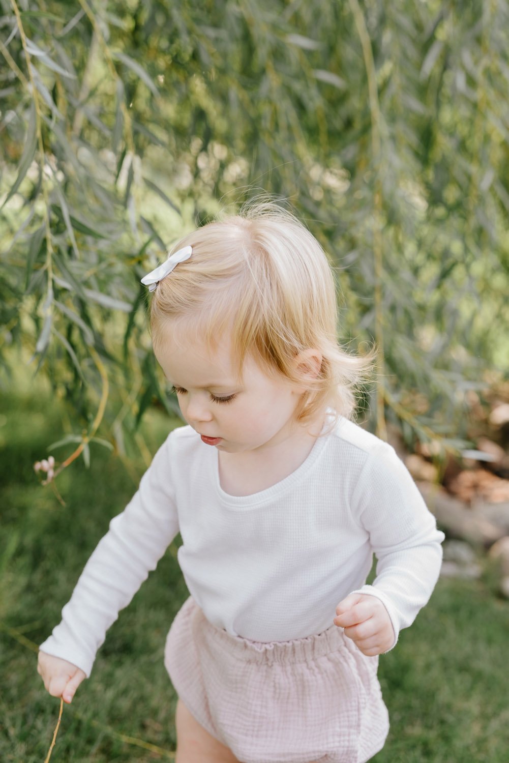 Little girl playing with stick.JPG