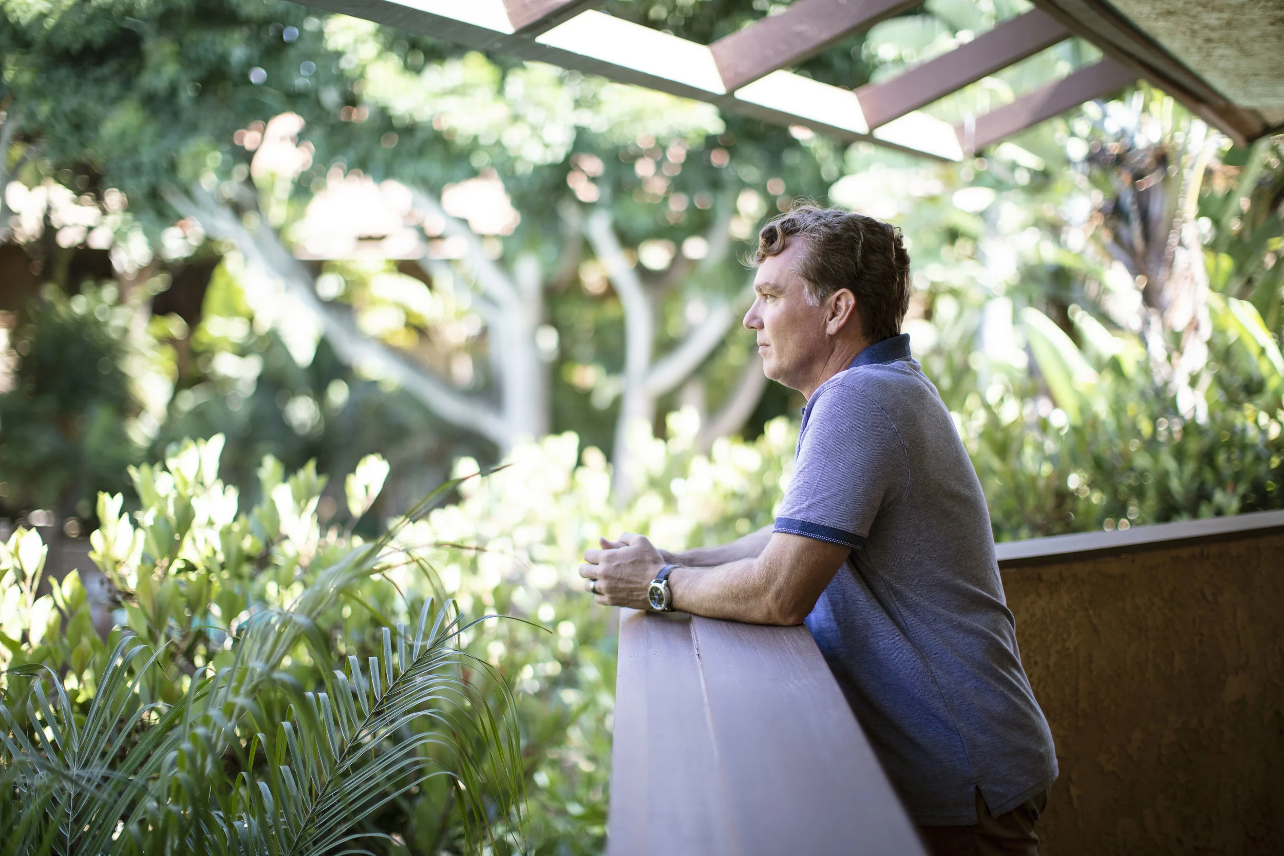 Man looking over balcony 