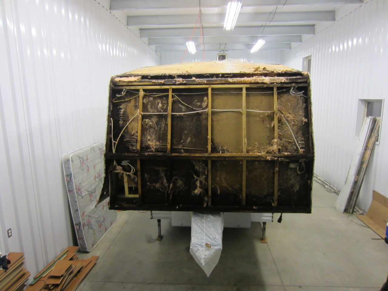 View of the front of the RV, where our bedroom is located. That's A LOT of rotted wood!