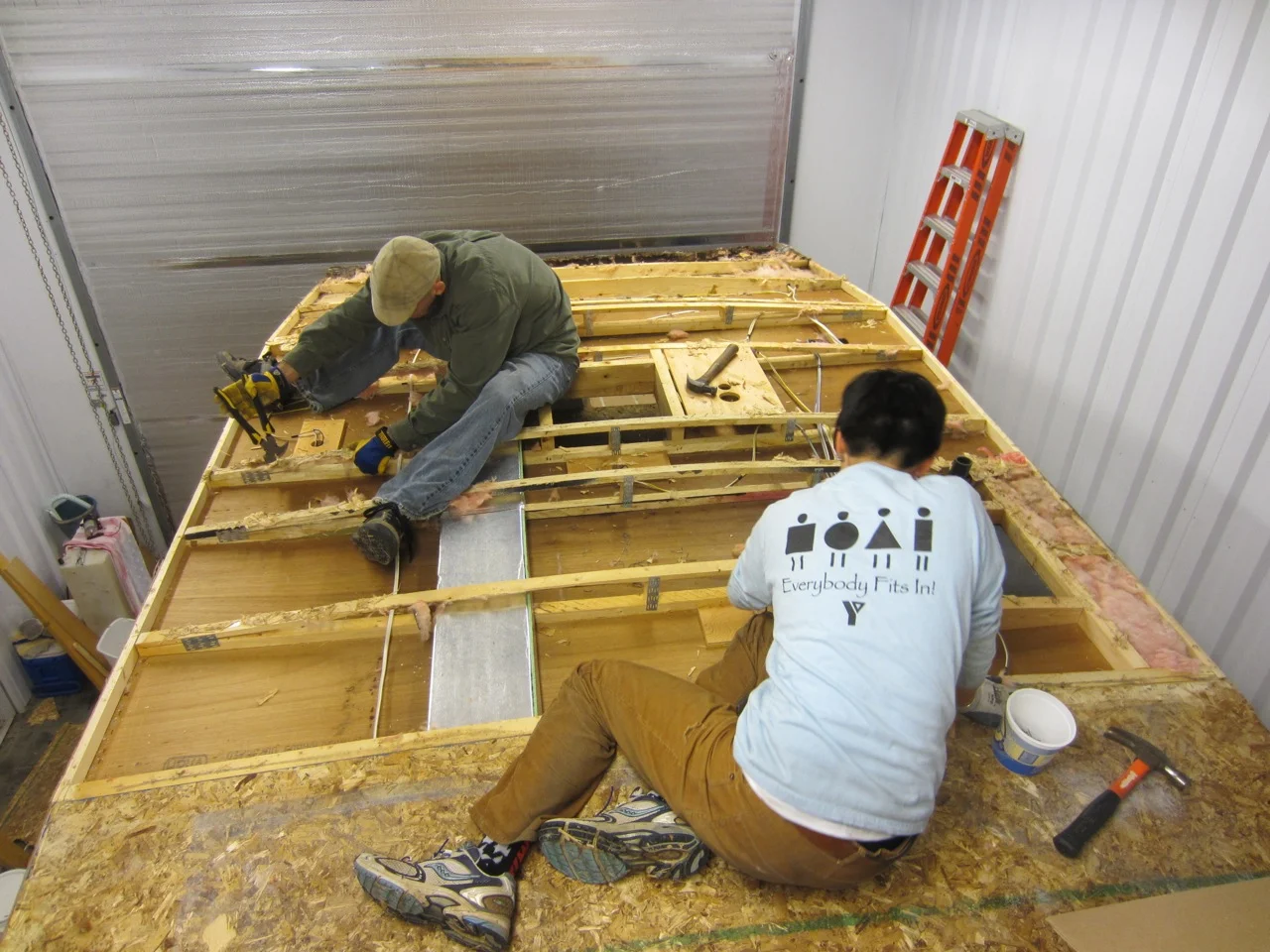 Steps to removing the roof: 1) Pull the wood off using a pry bar and brute strength (it's glued and stapled down tightly). 2) Remove the insulation (we packed it up for later use). 3) Remove all the staples left behind. 4) Drink some beer. 5) Repeat.