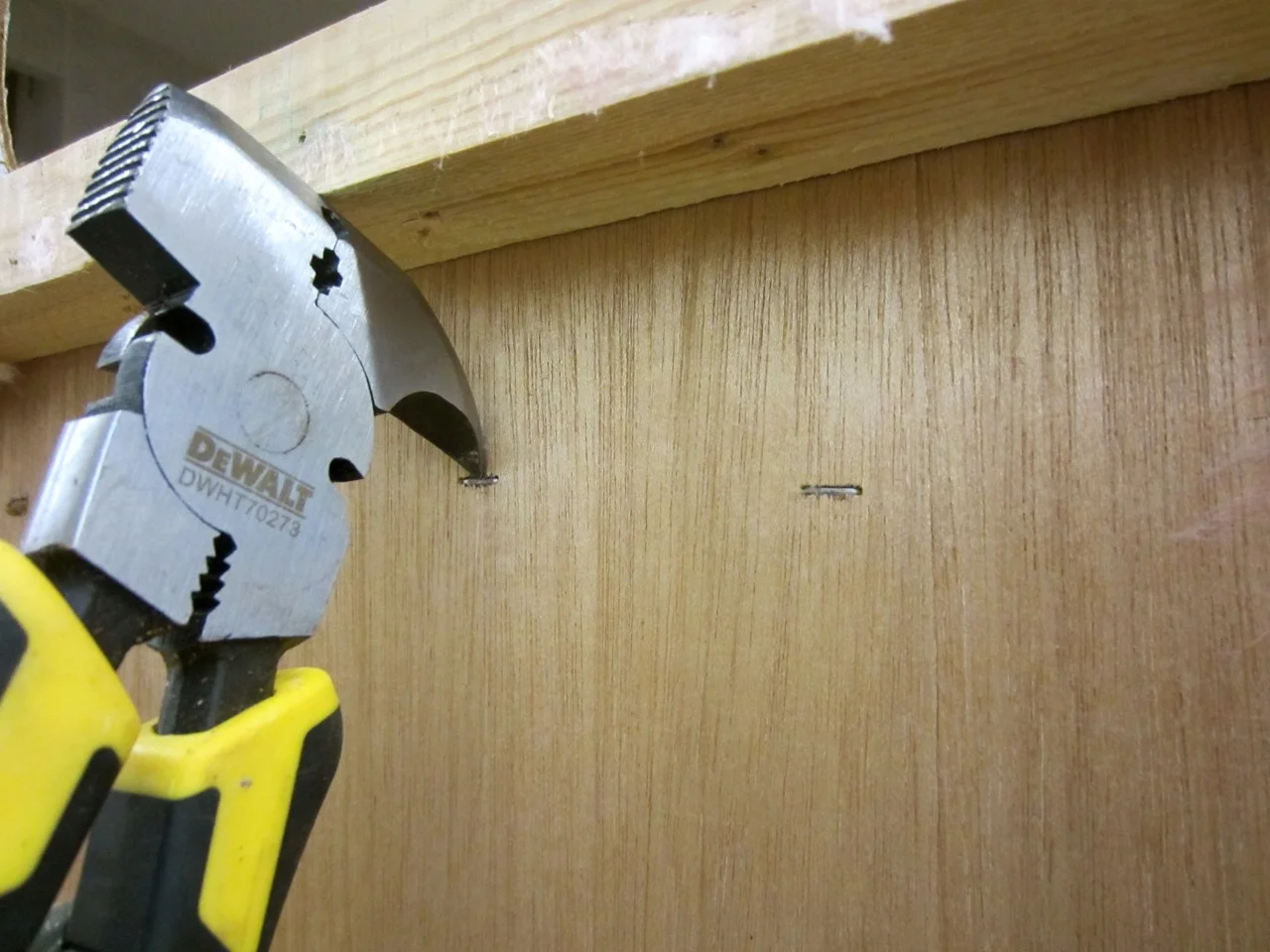 We had to remove all the staples that keep the cabinets attached to the walls. Go get yourself a pair of fencing pliers!