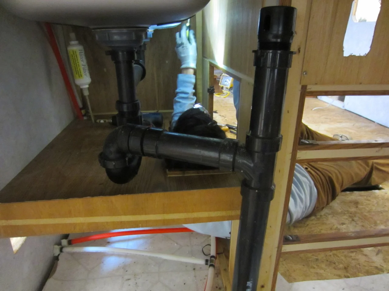 Awkward positions are necessary to unscrew the kitchen sinks and cabinets from inside and above.