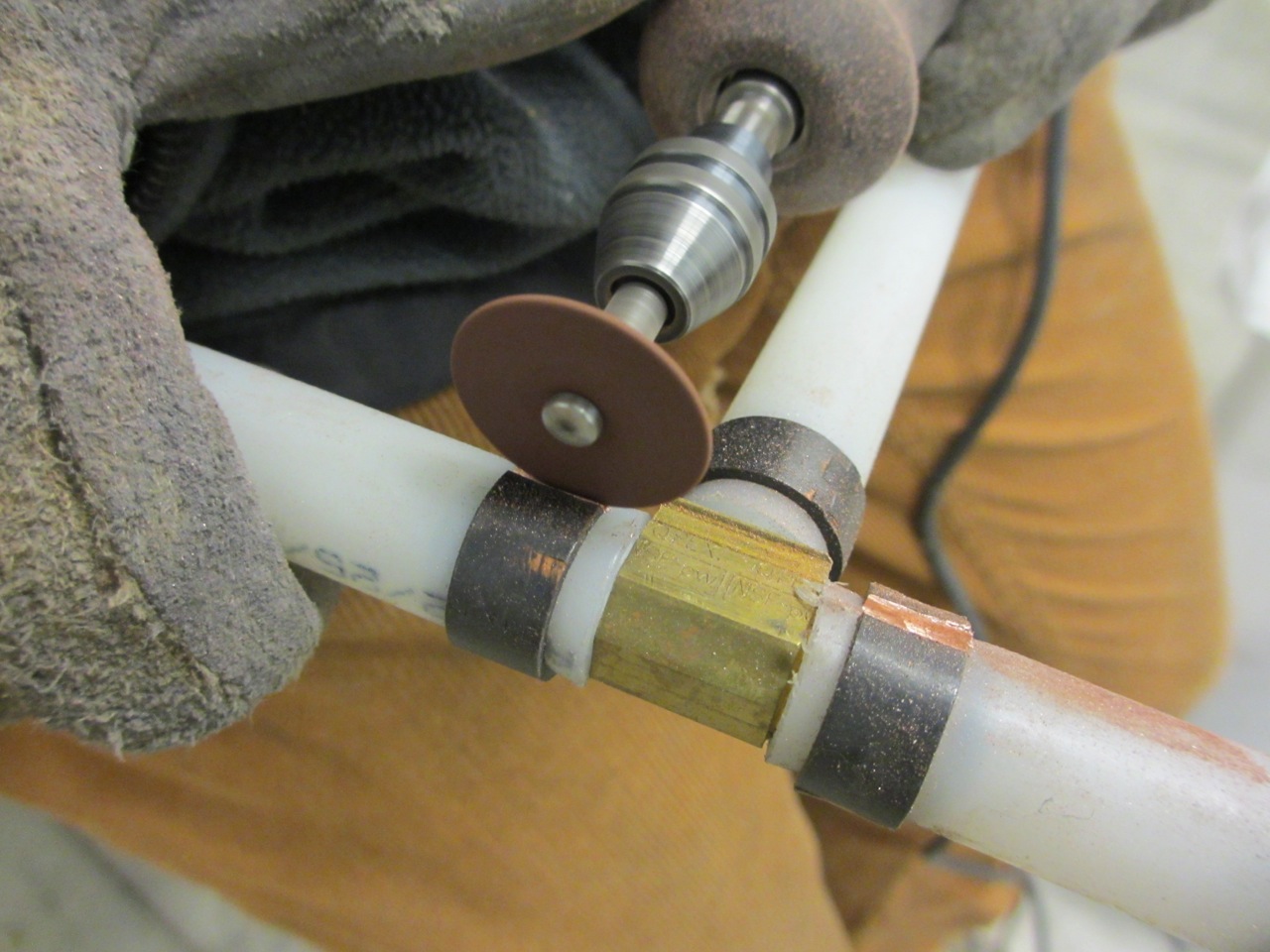  We used a Dremel to cut off all the copper clamps from the water pipes so we could remove and reuse the brass fittings. 