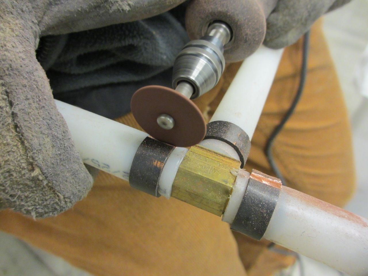 We used a Dremel to cut off all the copper clamps from the water pipes so we could remove and reuse the brass fittings.