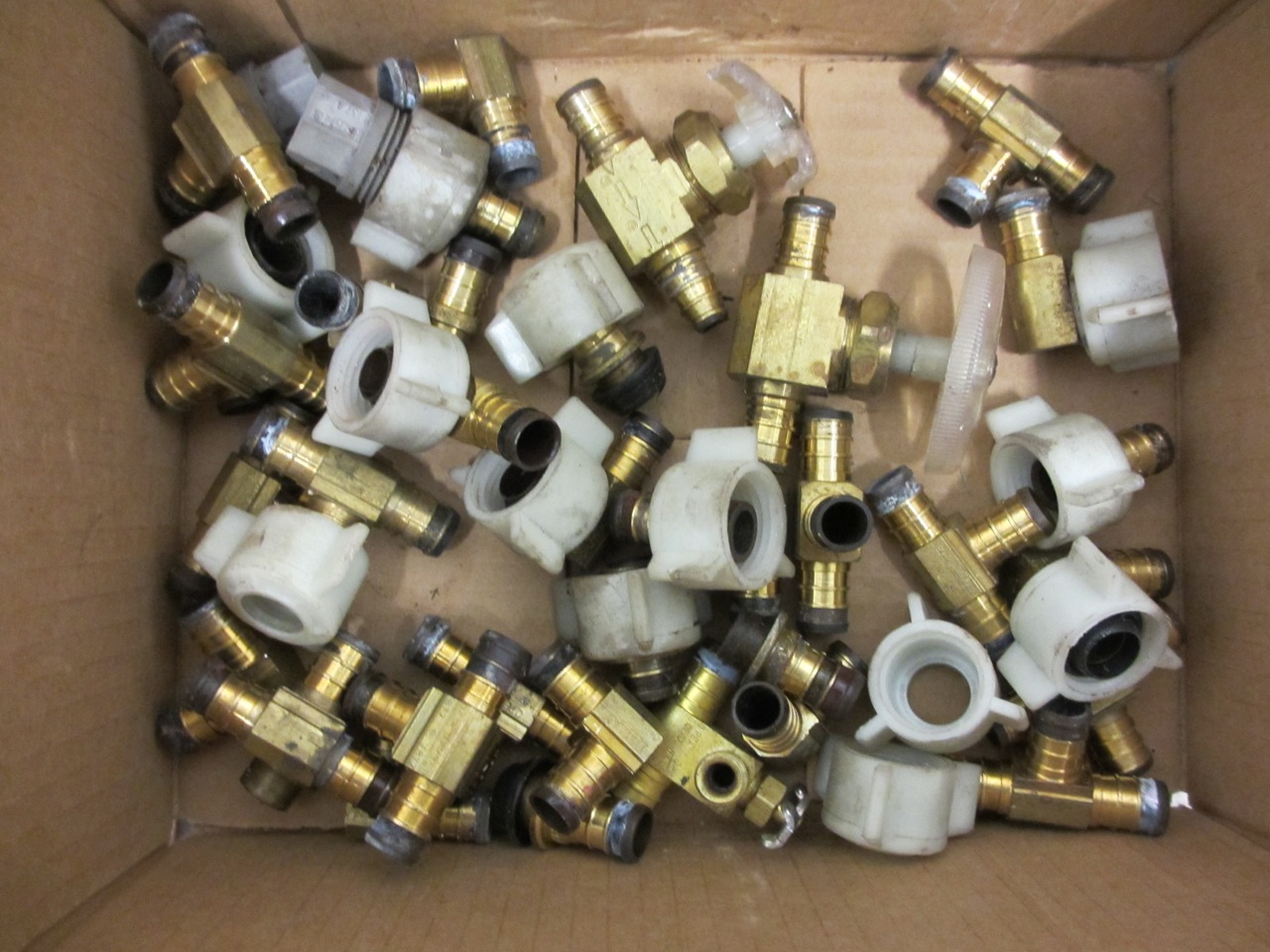 Box full of brass fittings to be reused.