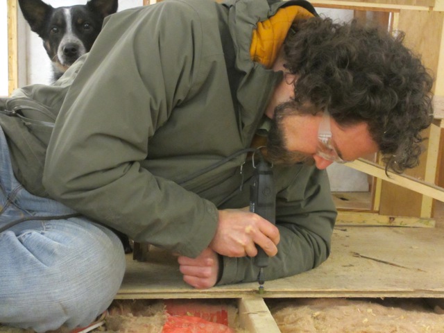 Jerud used the Dremel to clean out the groove in the existing sub-floor to make sure the new sub-floor would slide in perfectly.