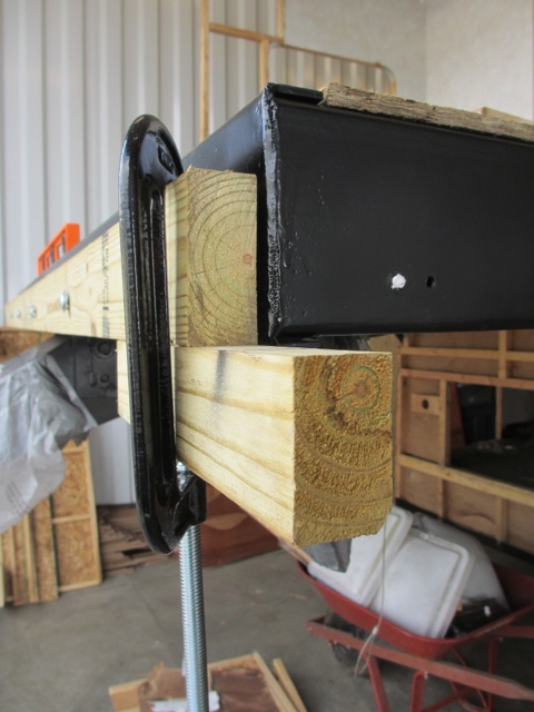 We clamped an extra wood piece under the front sill plate so we could place the side sill plate on it to line up the screw holes.