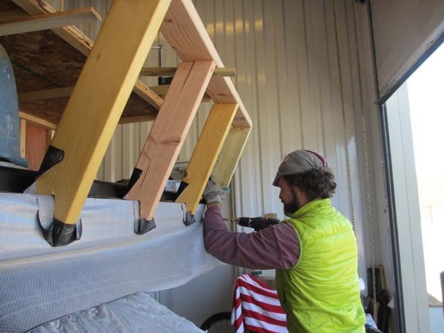 Screwing the new bedroom front wall studs to the RV.