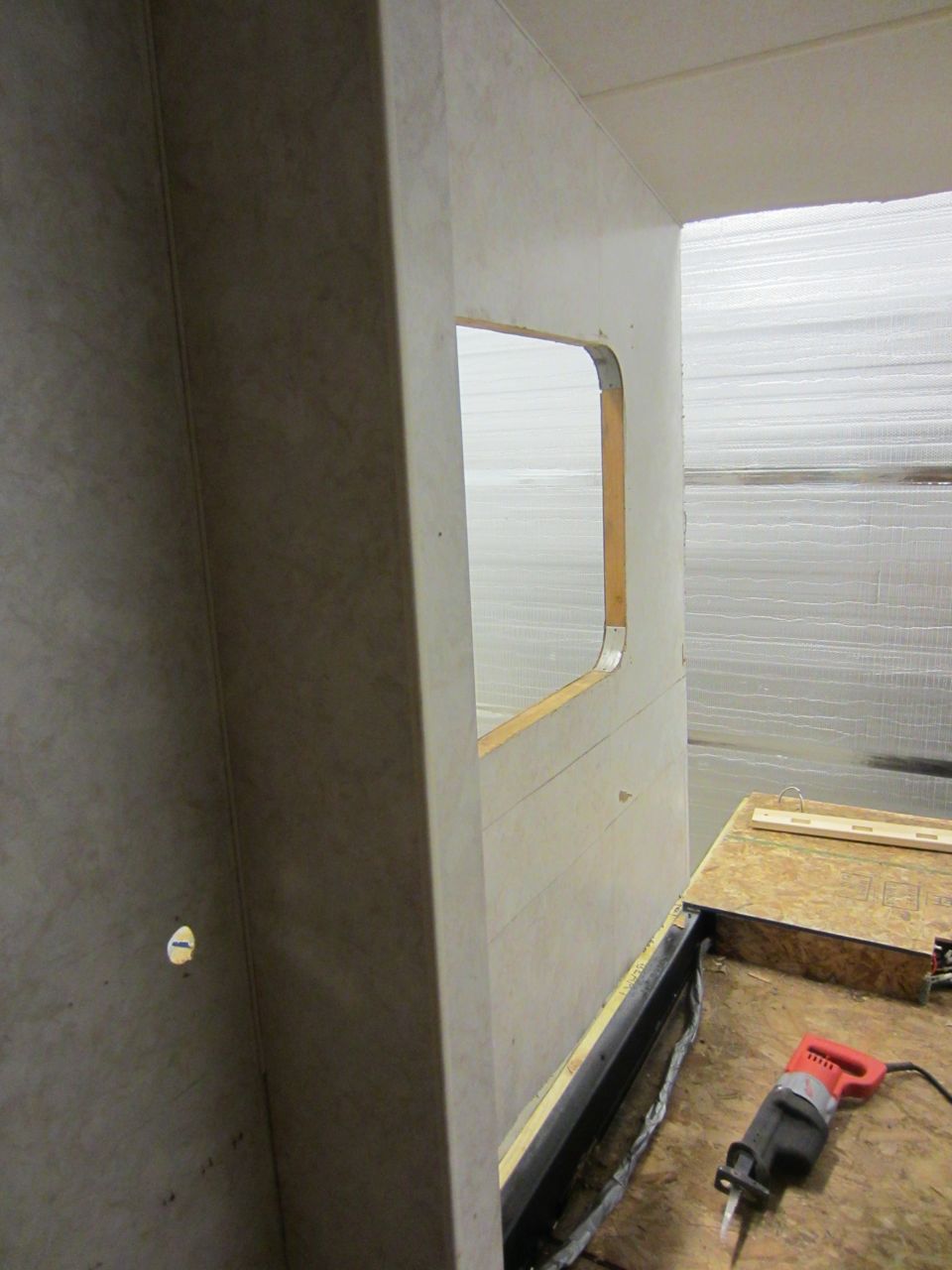 This smaller divider walls separated the bedroom from the bathroom sink and was located on the driver side of the rig.