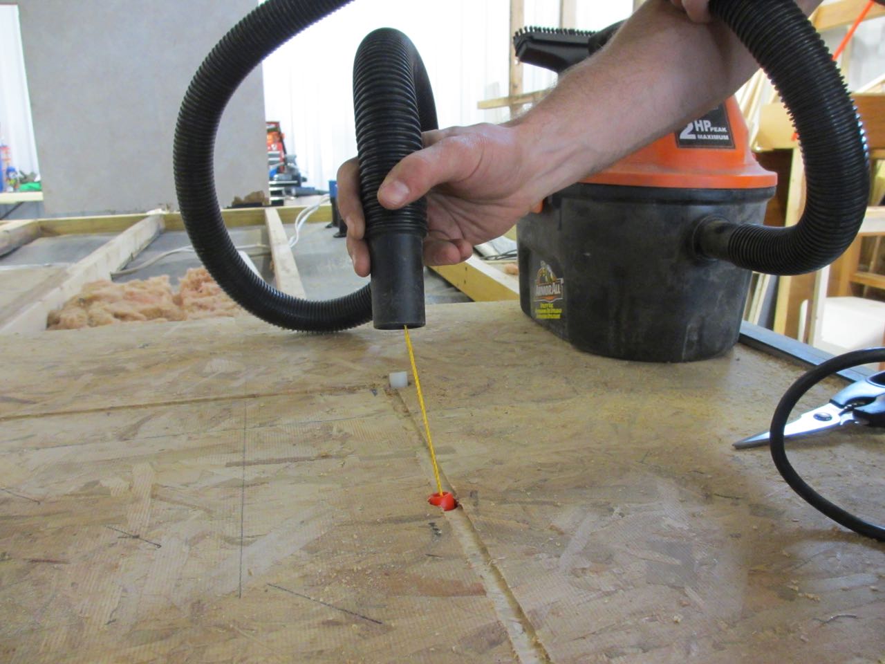 And used a vacuum to suck the string out the other end of the pipe. Then we stuck the string down the white pipe.