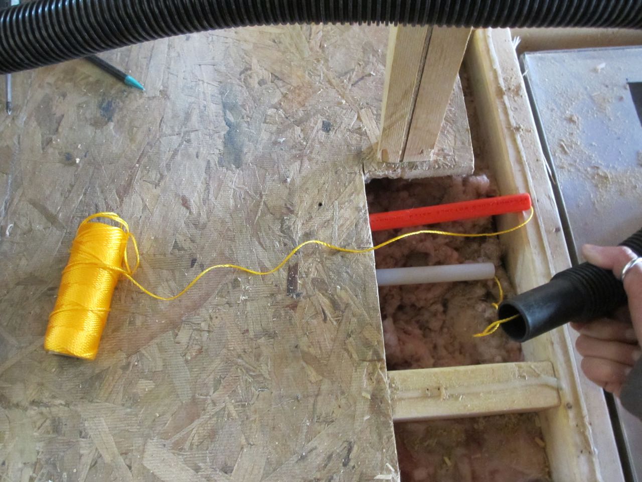 And vacuumed it out the other end of the white pipe. We used the string to actually pull the wires through.