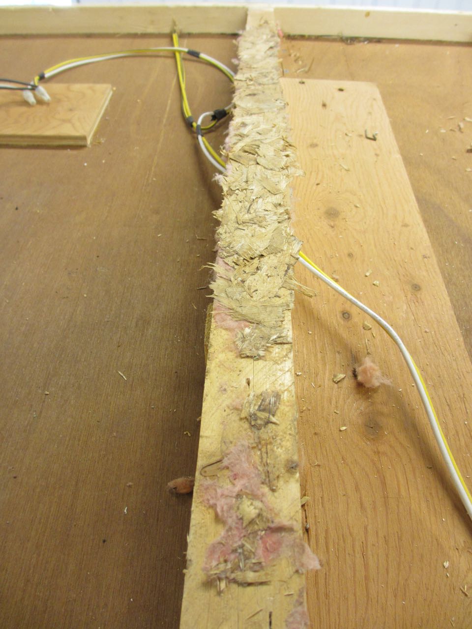  Beams are covered in glue and pieces of the original roof plywood. 