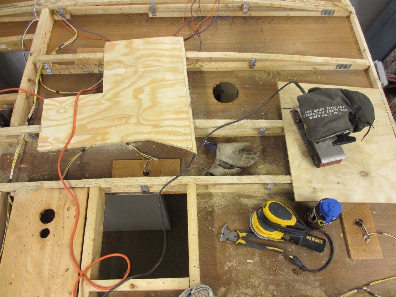  The set up on the roof to be able sand the roof beams. The weird shape board is used to sit/kneel on when sanding. 